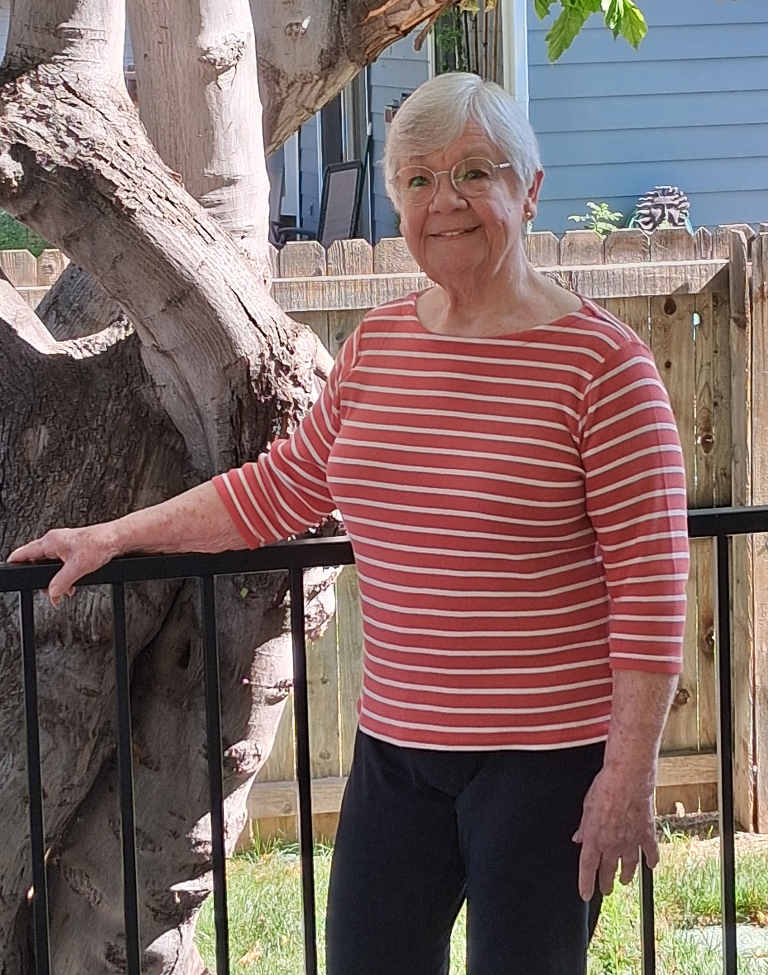 Steffani McChesney standing outdoors in her garden after months of movement coaching